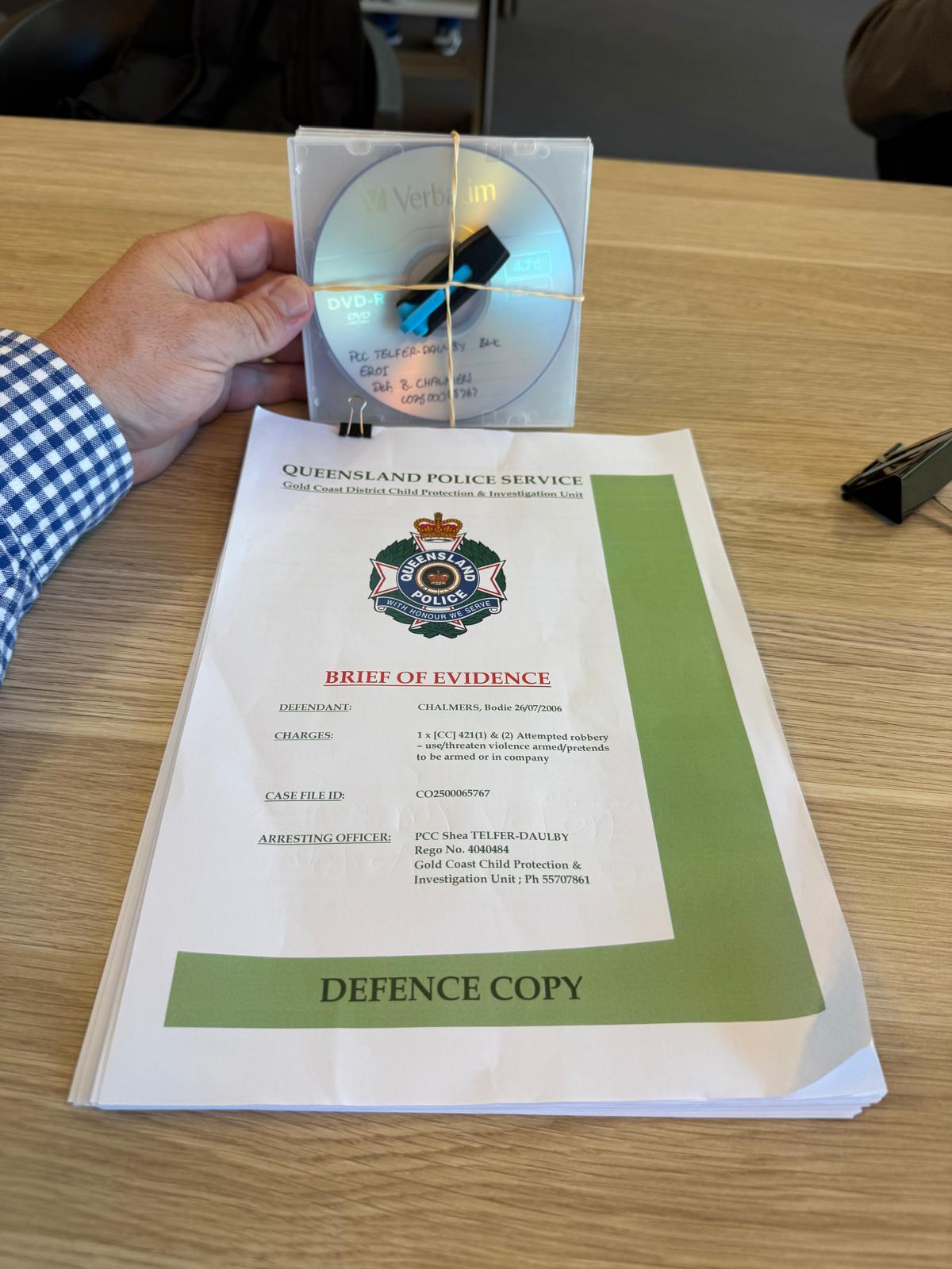 Adam Watson holding Bodie Chalmers's aggravated burglary brief