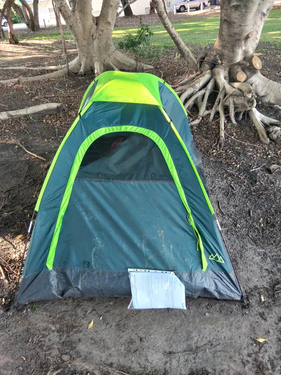 The tent at Albert Waterways Park with the Council Advice Note placed against it